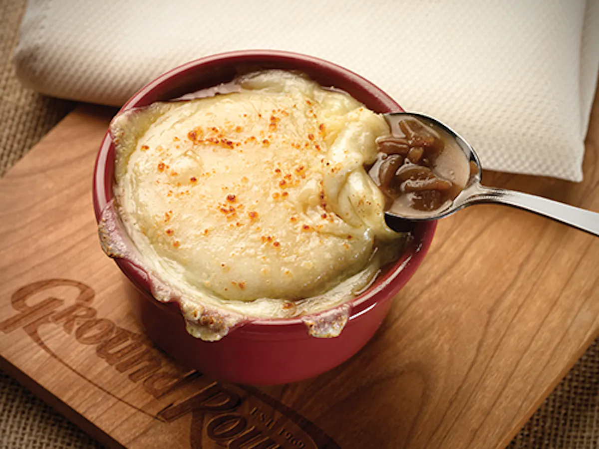 a bowl of food sitting on top of a wooden table